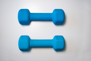 Two blue dumbbells isolated on white 