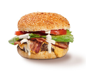 American style cheeseburger with white sauce bacon cheese lettuce tomato isolated on white front view arrangement on white background in studio close up