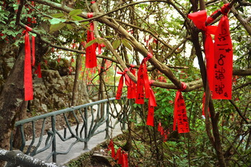 Zhangjiajie, China - May 10, 2017: Detail of red ribbons in Wish Forest Zhangjiajie National Park, China.