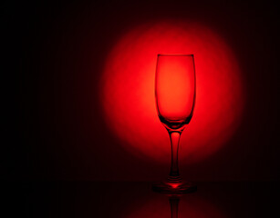 an empty wine glass with a beautiful red gradient background
