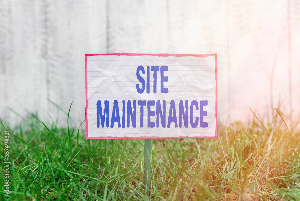 Fototapete Text sign showing Site Maintenance. Business photo text Monitoring and regularly checking your website for issues Crumpled paper attached to a stick and placed in the green grassy land