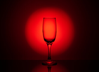 an empty wine glass with a beautiful red gradient background
