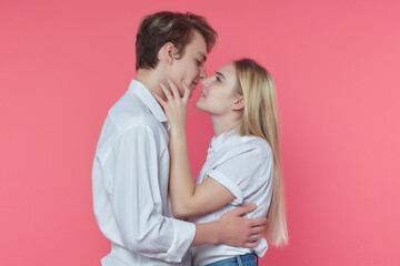 guy and girl in the Studio. expression of emotions and love. pink background