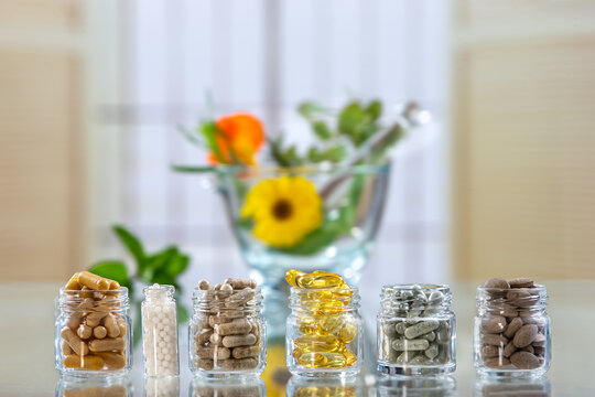 herbal medicine , food supllement capsules, capsules, green, herbal, , medicine, mortar, natural,product portar and medicine flower on background
