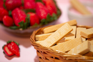 strawberry cream flavored wafer with blurred strawberries in the background..