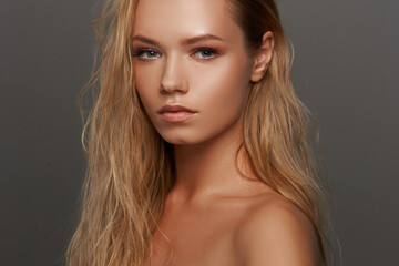 Closeup face fashion beauty portrait of young beautiful caucasian blonde woman with wet hair and...