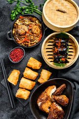 Chinese food. Noodles, dumplings, stir fry chicken, dim sum, spring rolls. Chinese cuisine set.  Black background. Top view