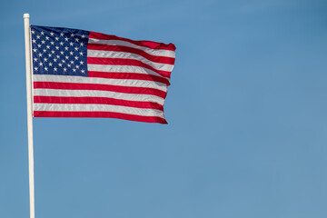 american flag against blue sky copy space