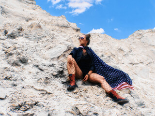 Girl with american flag on her neck sitting and looking ahead