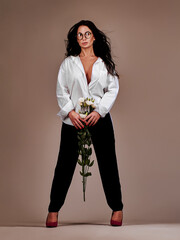 Stylish woman with flowers. Beauty close up studio portrait