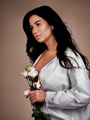 Stylish woman with flowers. Beauty close up studio portrait