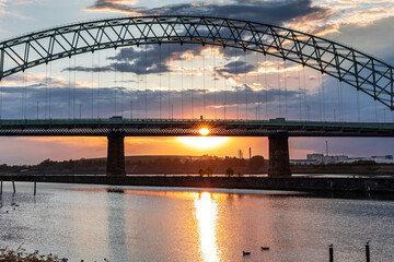 Silver Jubilee Bridge in Runcorn with the sun setting in the background