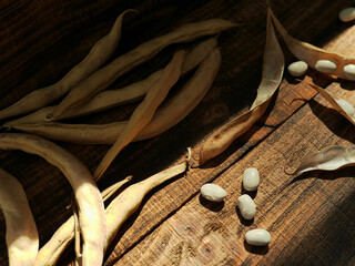 white kidney beans on wooden background. Dried organic harvest of white beans
