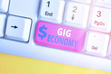 Writing note showing Gig Economy. Business concept for a market system distinguished by shortterm...