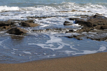 Incoming tide reaches the beach