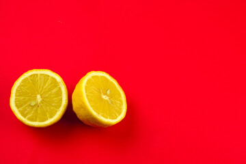 sectional view of lemon on a bright red background, lemon peel, citrus juicy fruit, product for...