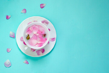 tea of flowers and rose petals on a delicate background, a drink of roses, the concept of tenderness and freshness