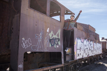 Woman having fun in an abandoned train