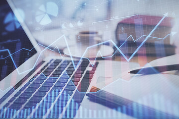 Double exposure of financial chart drawing and desktop with coffee and items on table background. Concept of forex market trading