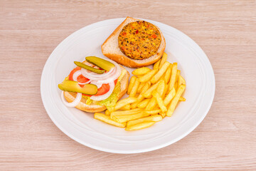 Burger with potatoes on wooden background