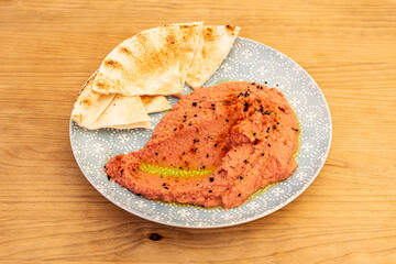 Plate of pink hummus with sourdough bread