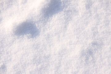 The pattern of snow in the sunlight from very close.