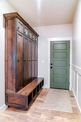 Hinged panelled wooden fire door with black knob and lock inside a home