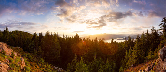 Obraz premium Beautiful Panoramic Canadian Landscape view from top of Mt. Gardener Hike with Howe Sound in Background during Vibrant Sunset. Located in Bowen Island, near Vancouver, British Columbia, Canada.