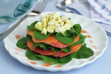 arugula salad, salmon carpaccio, goat cheese and balsamic vinegar