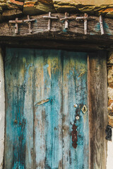 old wooden door with blue shutters