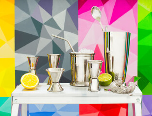 Mint julep whiskey cocktail in misted frozen metal glass and bar accessories shaker jigger spoon...