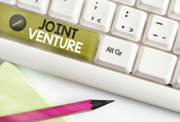 Writing note showing Joint Venture. Business concept for business partnership invested jointly by...