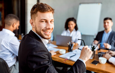 Young Entrepreneur Posing Sitting During Business Partners Meeting In Office