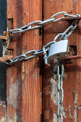 Old painted wooden door with chain and padlock, old town, Crakow, Poland.