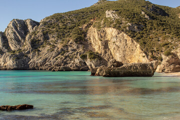 Fototapeta na wymiar Ribeira do Cavalo is a paradise beach with crystal clear blue waters in the town of sesimbra , Portugal