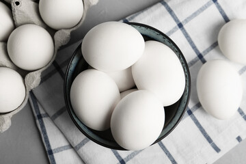 Flat lay composition with raw chicken eggs on grey table