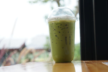 cup of green tea smoothie on the coffee shop table