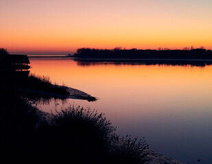 Sunset of Caorle, Venice: Wonderful colors of the winter sunset in Caorle with a view of the Madonnina dell'Angelo from the Venetian lagoon in Brussa