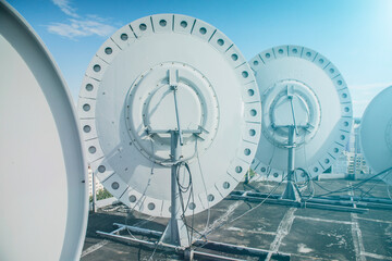 broadcast transmitting satellite dishes on the roof of the house