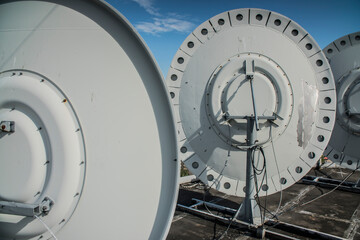 broadcast transmitting satellite dishes on the roof of the house