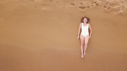 Beautiful girl with white swimsuit during  golden hour