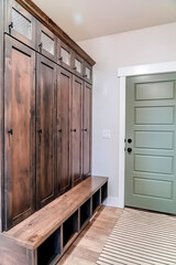 Home interior with fire door adjacent to the tall vintage wooden cabinet