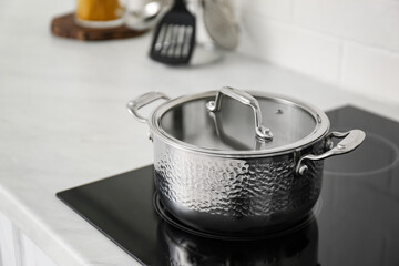 New saucepot on induction stove in kitchen