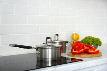 Kitchen counter with products and saucepan on stove