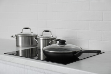 New cookware on induction stove in kitchen