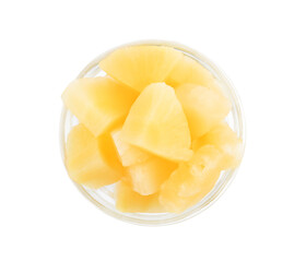 Pieces of delicious sweet canned pineapple in glass bowl on white background, top view