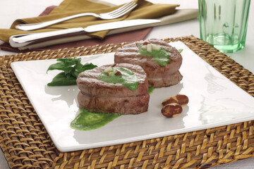 fillet medallion with spinach sauce and Brazil nuts