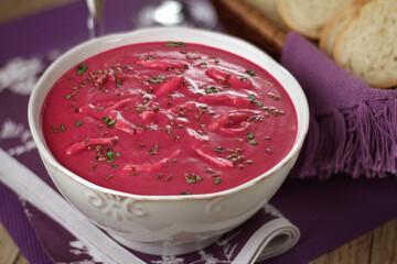 beetroot soup with shredded chicken, flaxseed and herbs