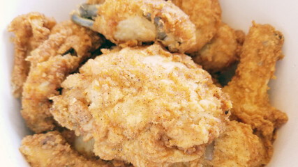 A bucket of fried chicken thighs, wings and drumsticks