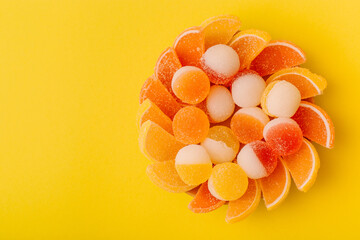 Macro photo multi-colored marmalade jelly candy's. Dessert marmalade in the form of lemon and orange slices. The sweetness of jelly candy yellow and orange. Copy space